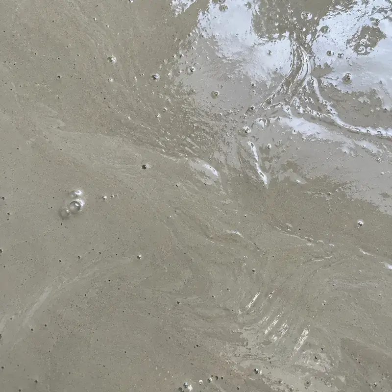 Top-down close-up of wet liquid screed